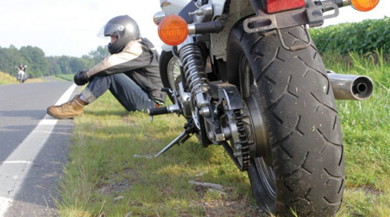 Motorcyclist stranded on roadside.